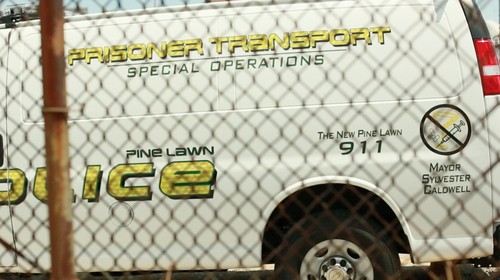 In a neighboring town to Ferguson, called Pine Lawn, police are perceived by many as an armed force of a corrupt mayor. In order to ensure his presence is felt, the mayor puts his name on all police vehicles. On the frontside of the van it also reads, "This is a zero tolerance community."