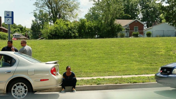 An image we saw often was community members being forced to sit on a curb by police. When we took this shot, just half a block down, another group of black teenagers were being detained by police on a curb as well.