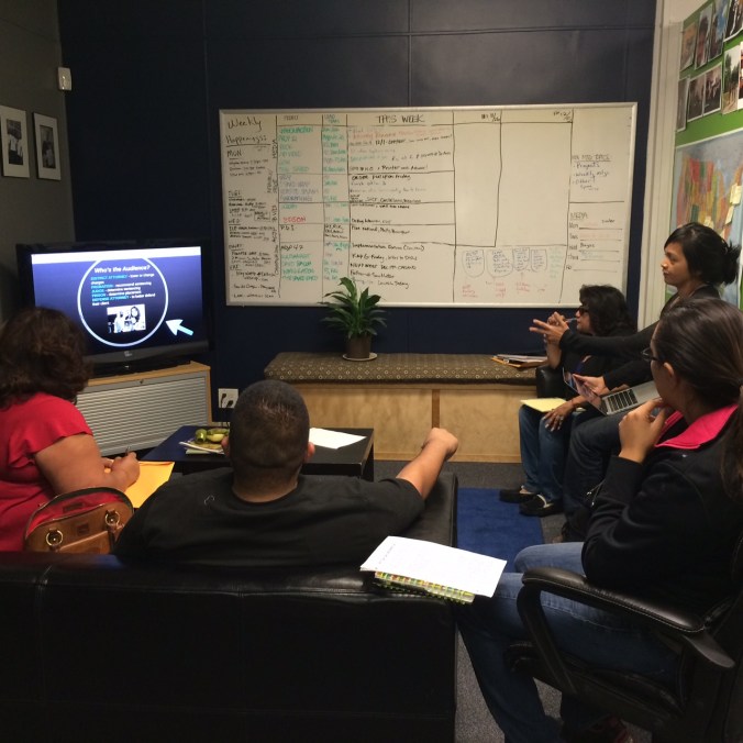In a small group setting, Charisse leas families through a presentation on creating effective mitigation packets.