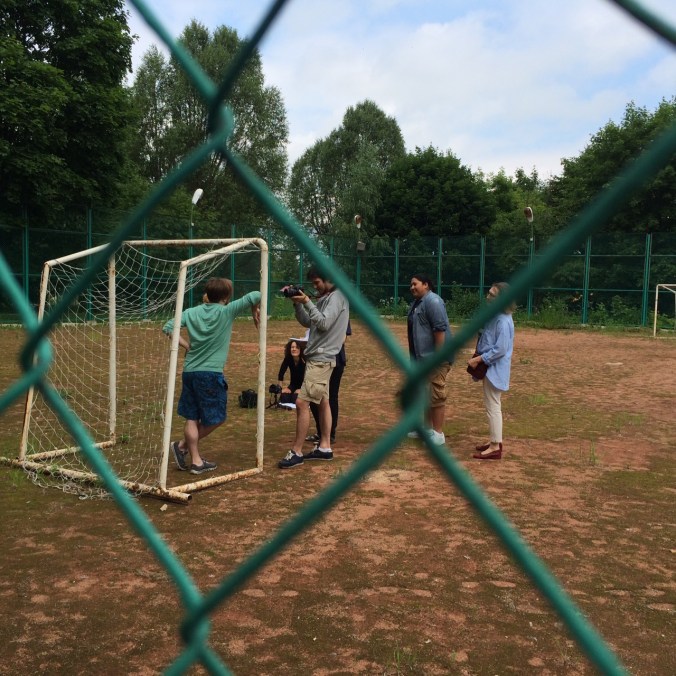 Some participants shooting a scene for the social bio video. In this scene, they had to pick a location that emphasized the role of the child -- so they went to a soccer field.